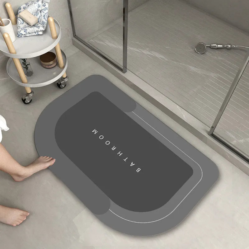 Blended fabric bathroom floor mat in blue colour, shown in an oval shape on a tiled floor.