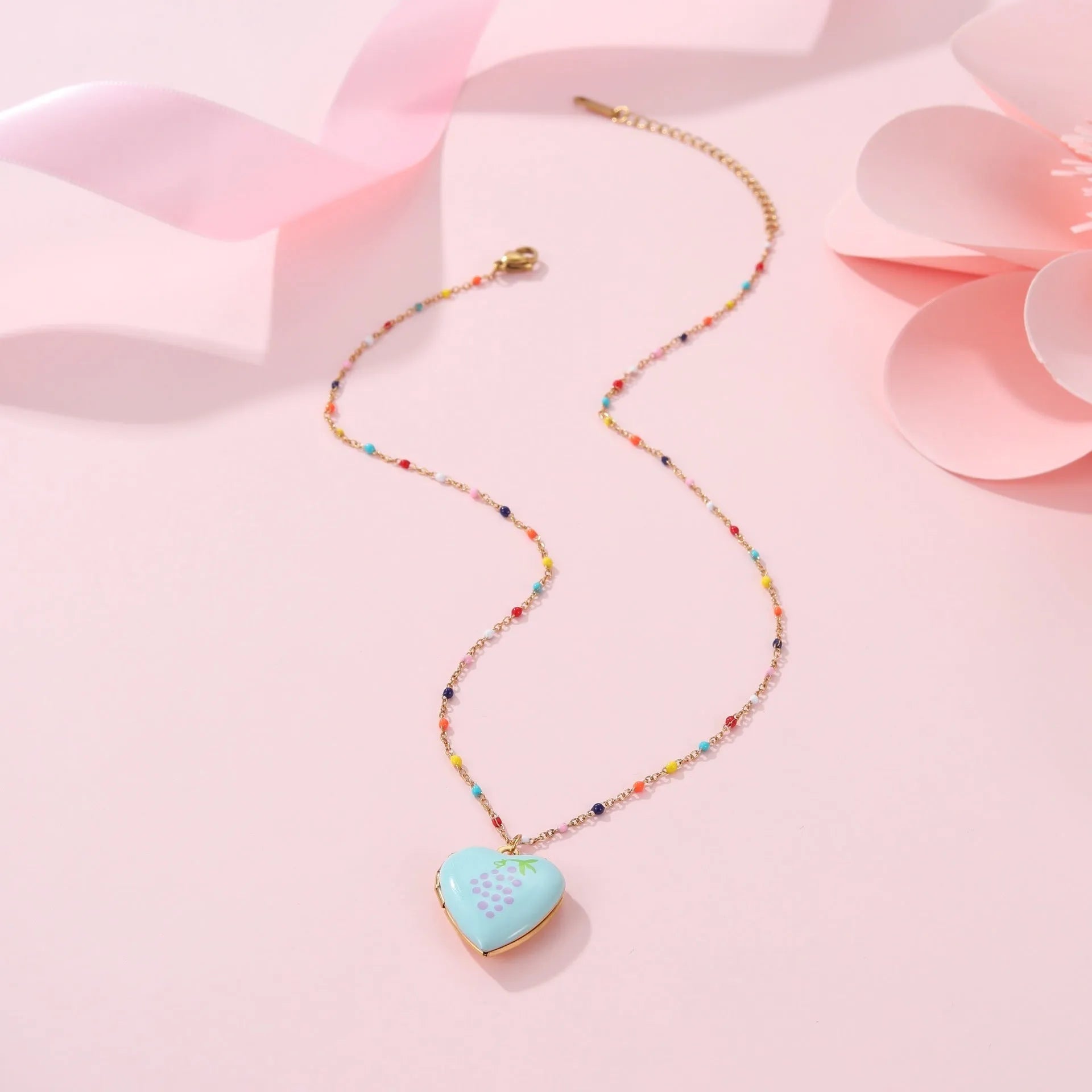 Stainless steel fruit pendant necklace with gold plating showing heart and fruit charm designs on adjustable chain
