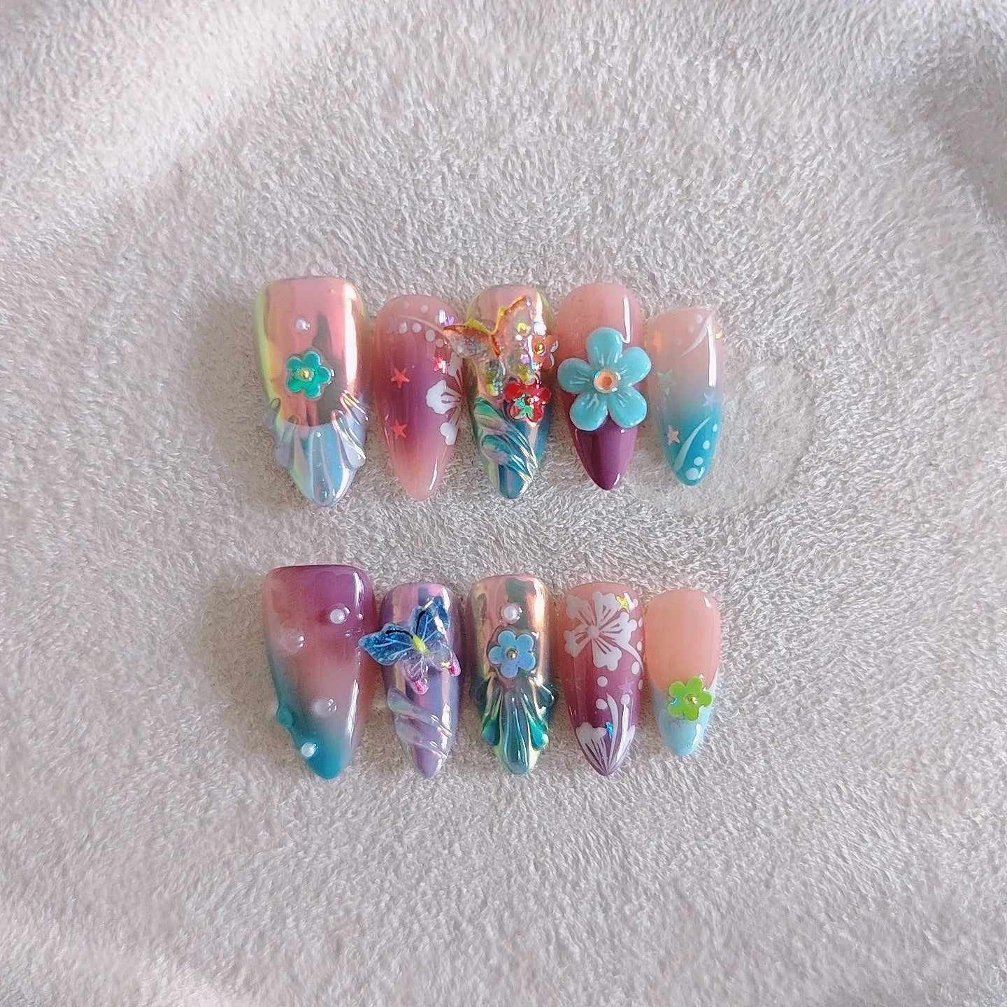 Handmade nail art sculptures with flower and butterfly designs for manicure decoration