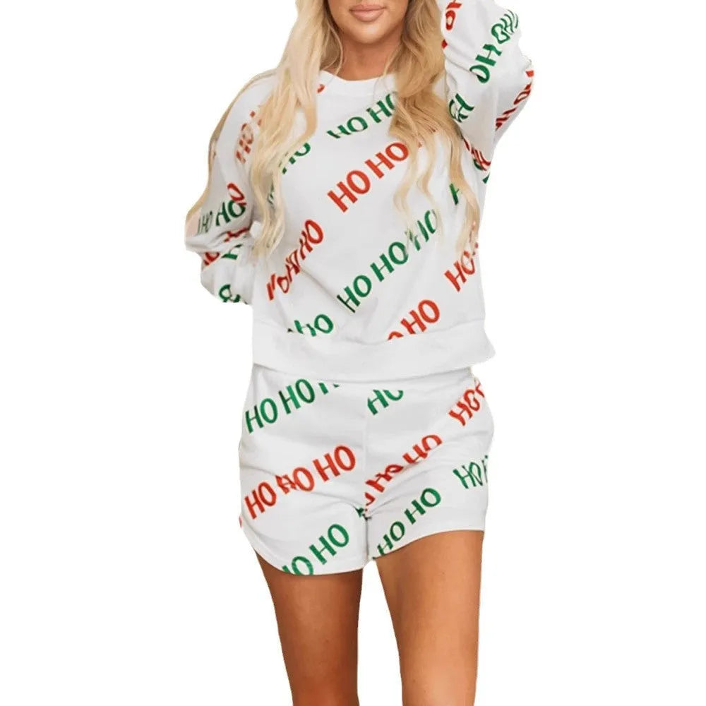 White women's two-piece suit with printed letters design, showing long-sleeved top and matching trousers