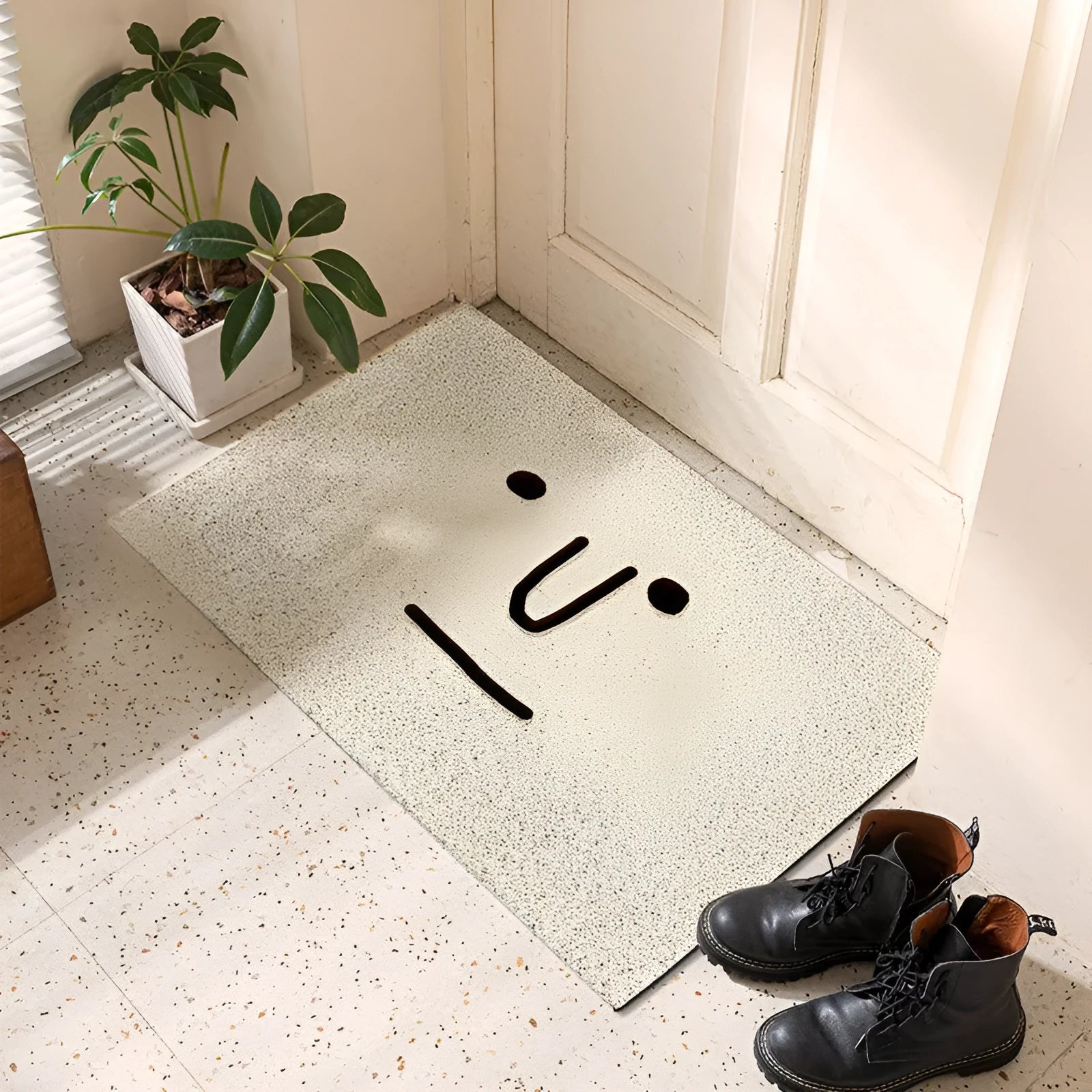Square PVC floor mat with a cartoon face and geometric pattern in Mr. Big Nose colour.