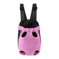 A small dog sitting in a breathable mesh carrier backpack worn on a person's front.