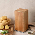 Xiangsi Wood Rotating Knife Holder in brown acacia wood with four strong magnetic sides on a kitchen countertop