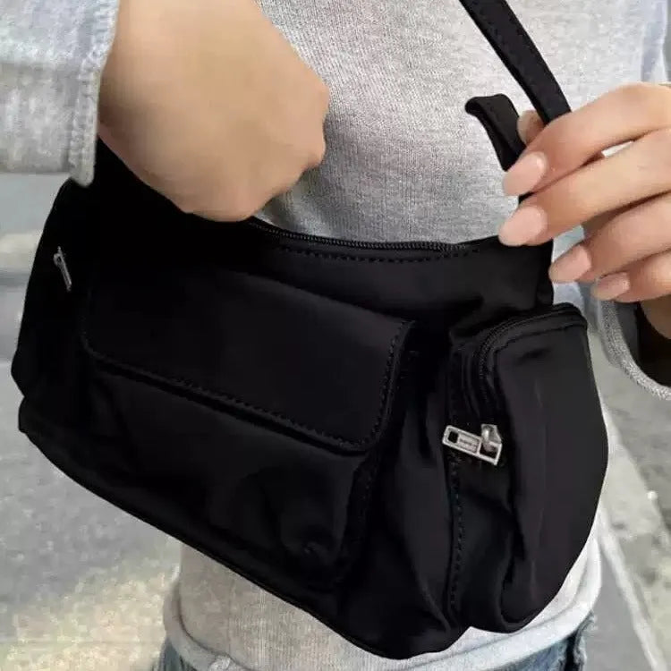 Black PU women's shoulder bag with two pockets, side-line detail, and a nylon lining.