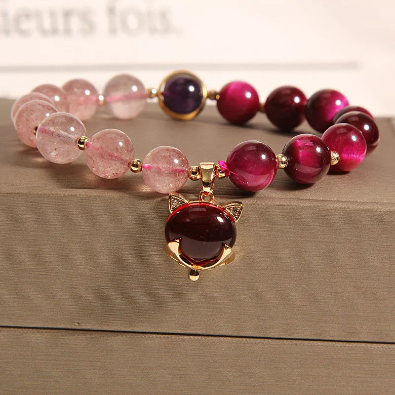 Women's strawberry crystal bracelet on elastic rope showing natural bead texture and uniform 18cm size