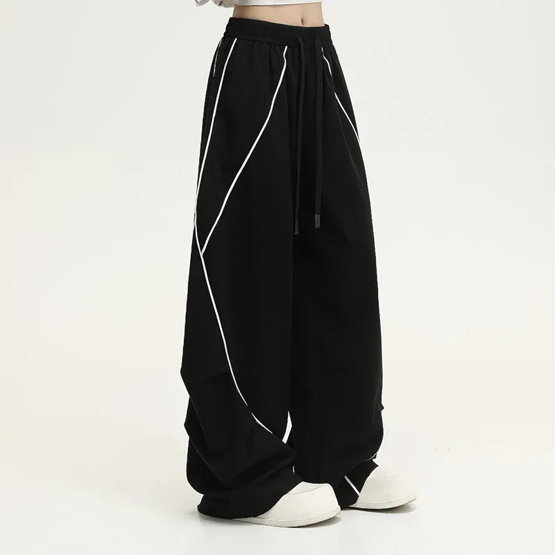 Black striped hip hop sports trousers with pleated wide-leg design on a mid waist