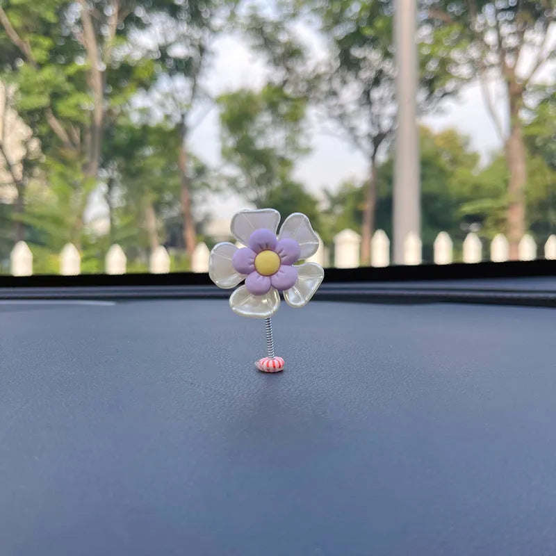 Small colourful plastic swing car decoration ornament in blue, green, pink, purple, or yellow.