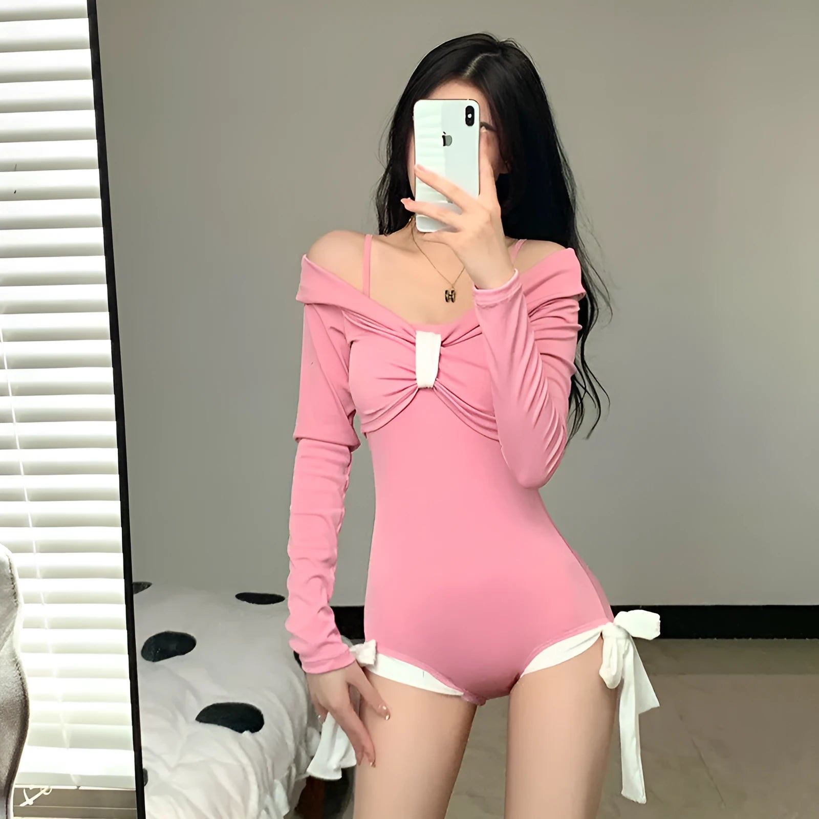 Women's long sleeve one-piece swimsuit in black or pink colours with polyester fibre construction