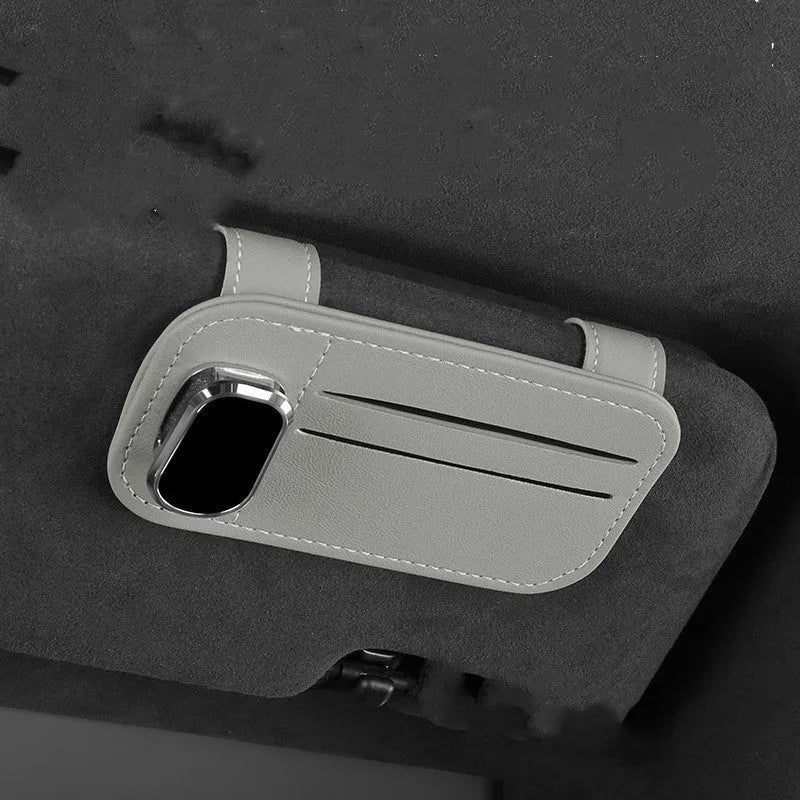Cowhide leather card holder clipped onto a car sun visor in a choice of colours.