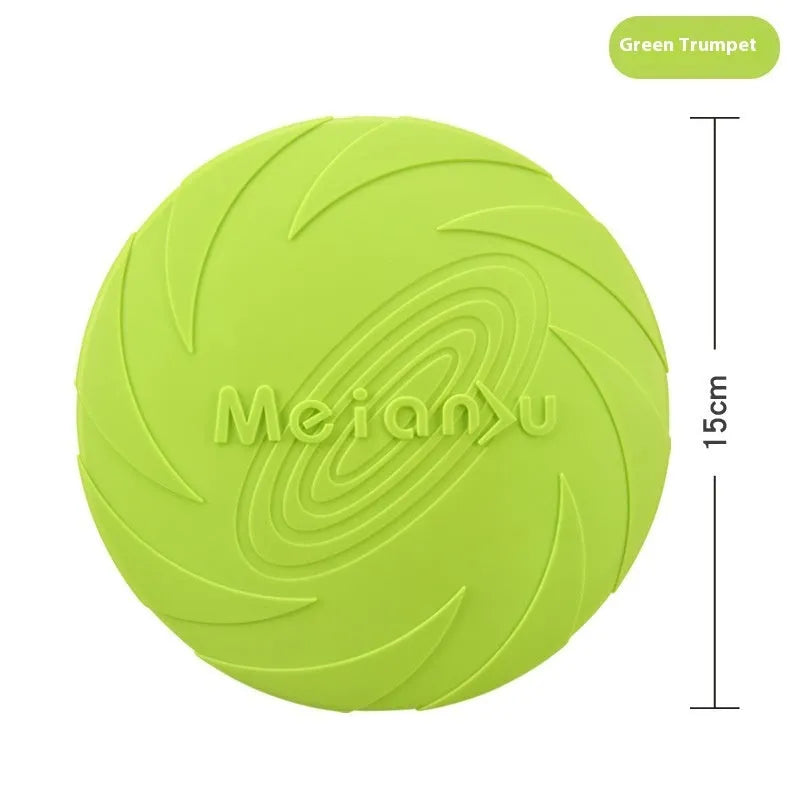 Soft rubber dog frisbee toy in blue, shown on grass for scale.