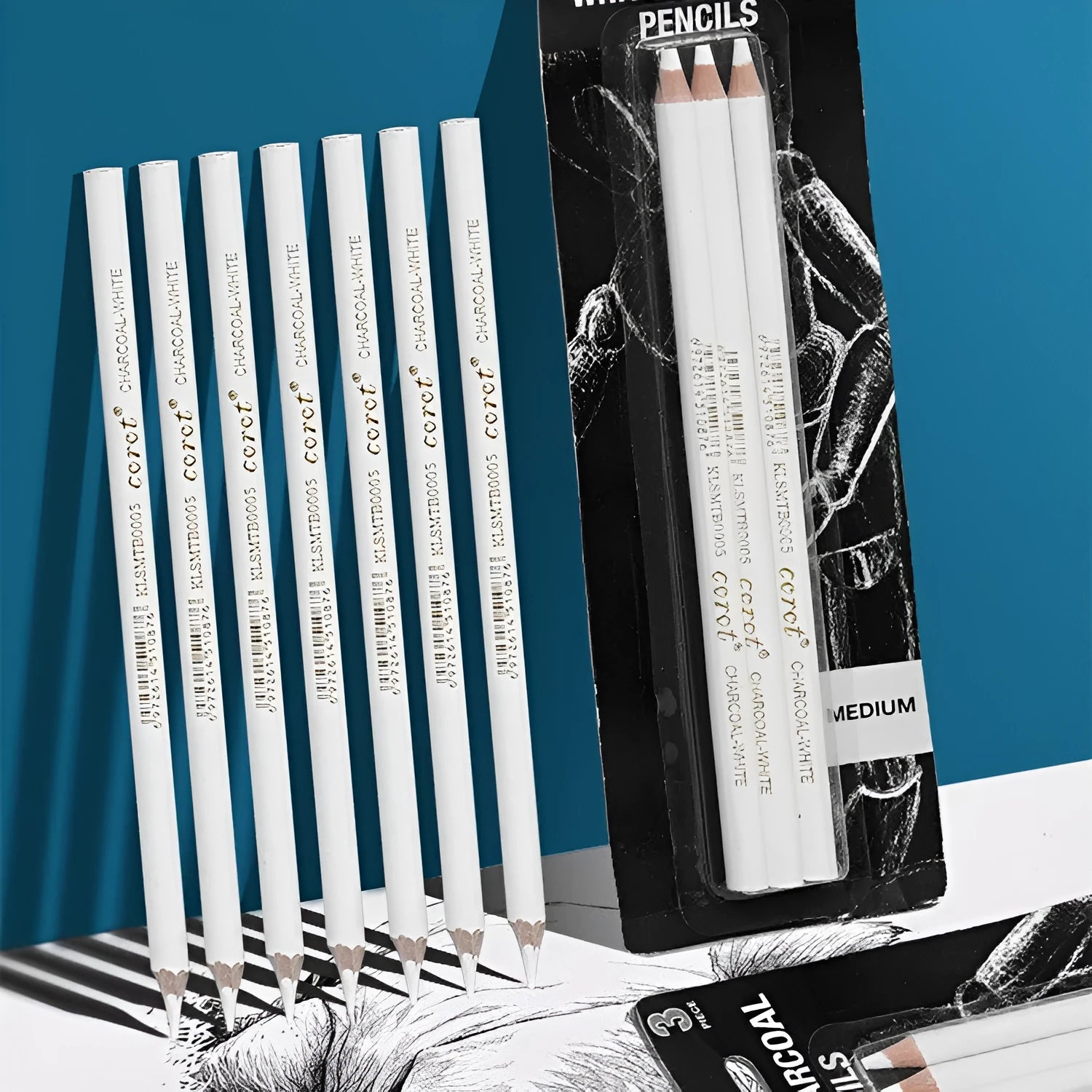 Three white charcoal pencils with wooden barrels and brush attachments for drawing