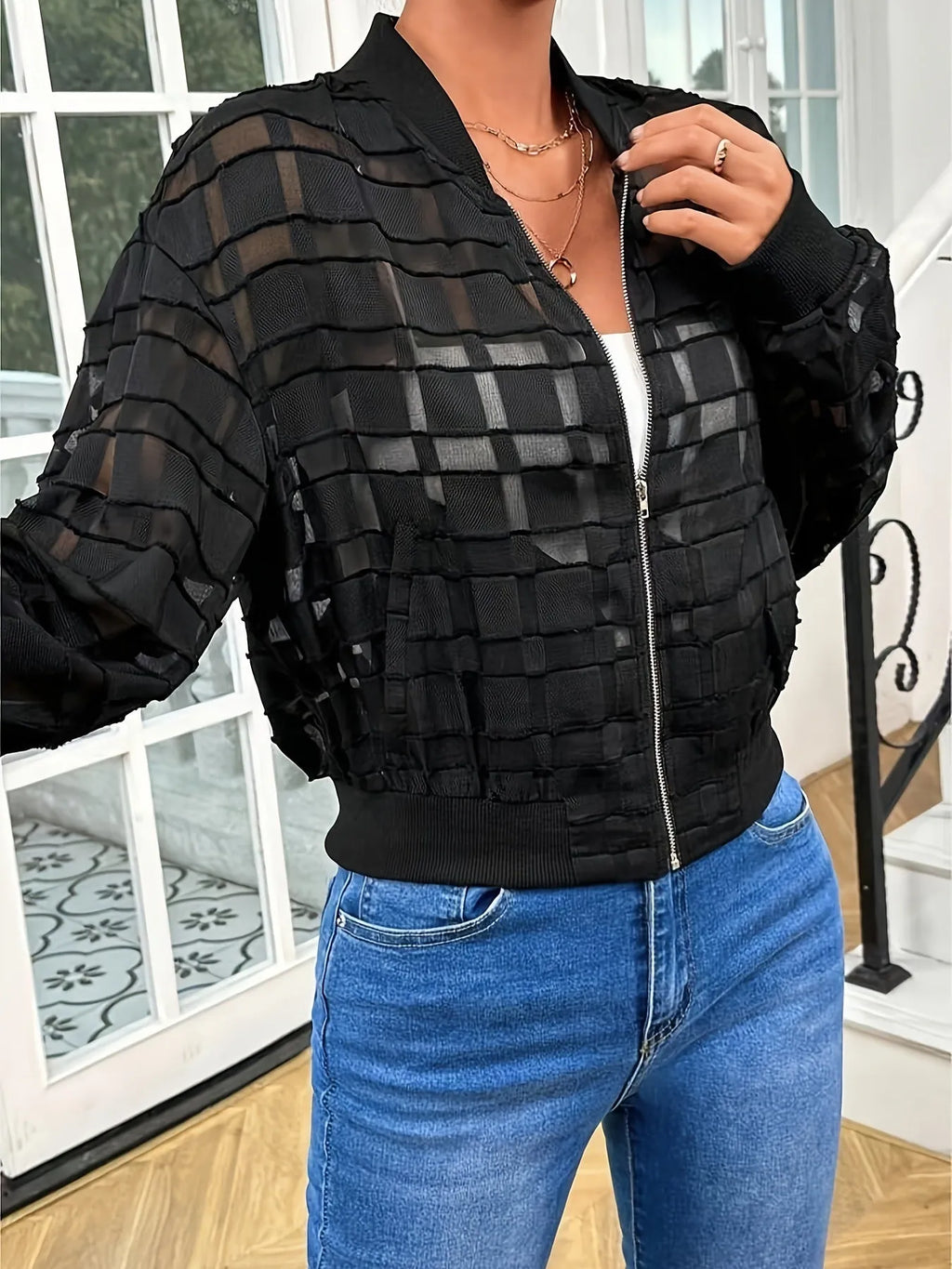 Black women's casual jacket with geometric pattern, semi-transparent fabric, front zipper, and long sleeves.