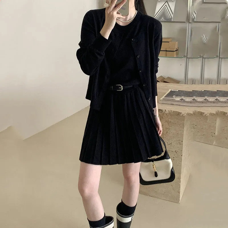 Women's grey knitted two-piece set with vest skirt, long-sleeved cardigan, belt, and 3D pattern detail