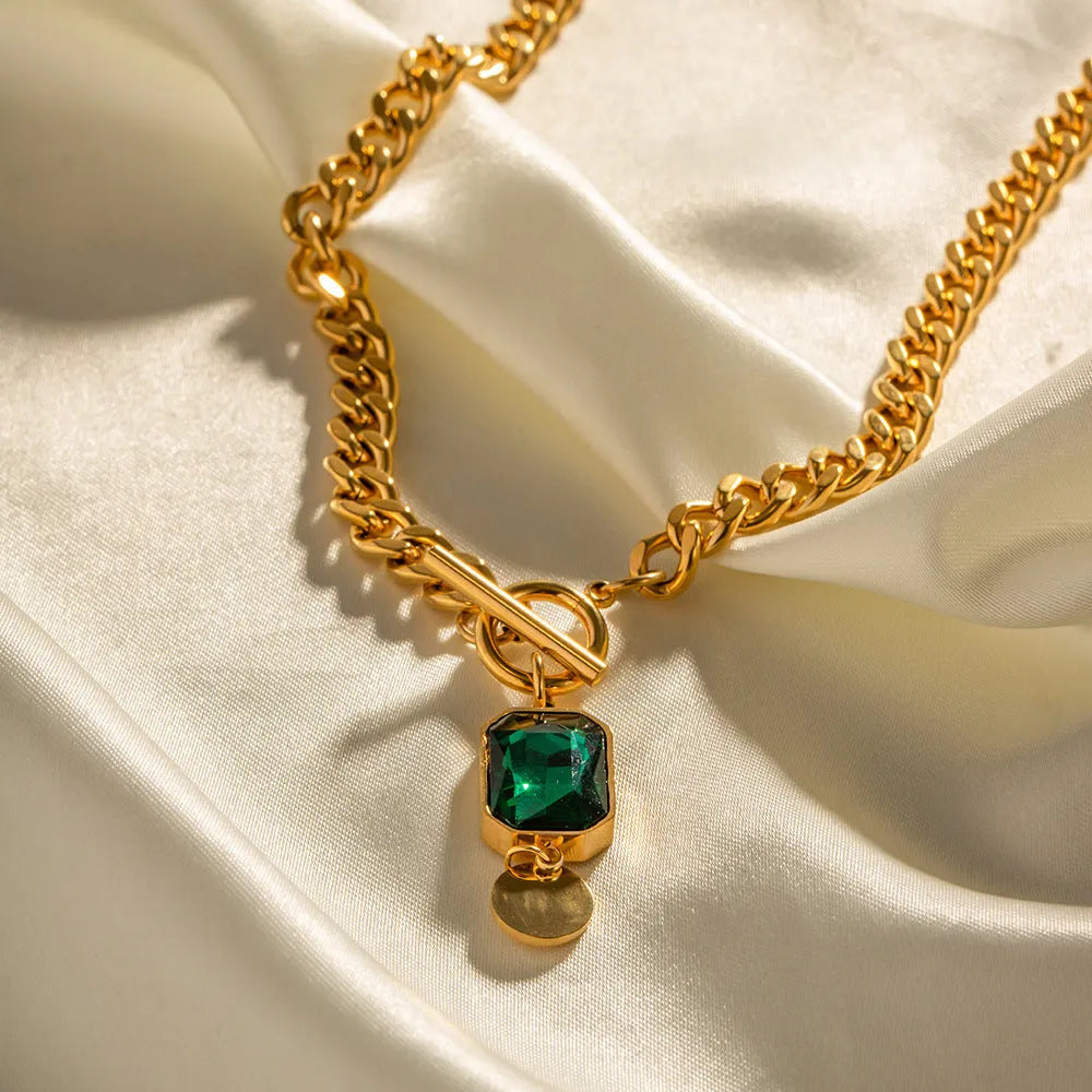 Gold electroplated titanium steel necklace with geometric round pendant on Cuban link chain