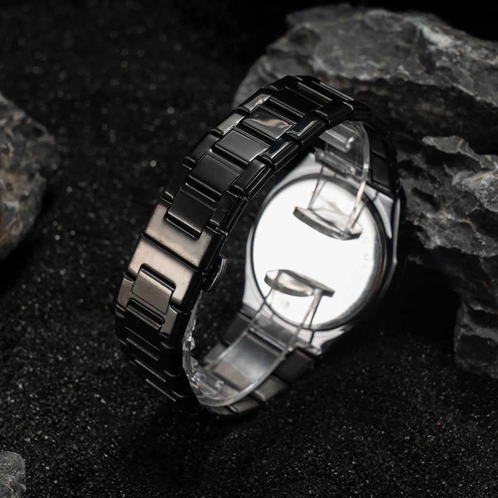 Men's steel bracelet quartz watch in business style on a wrist.