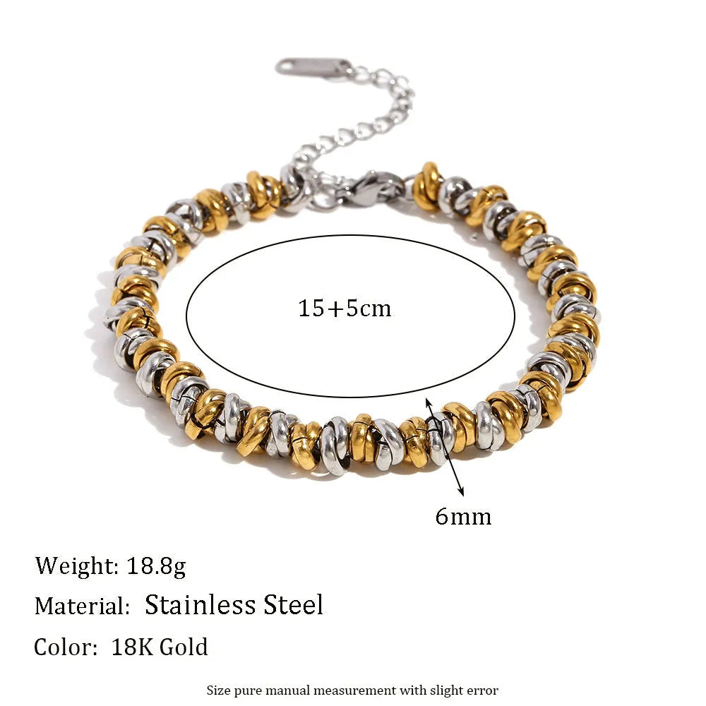 Women's geometric gold stainless steel jewellery set showing earrings, bracelet and necklace