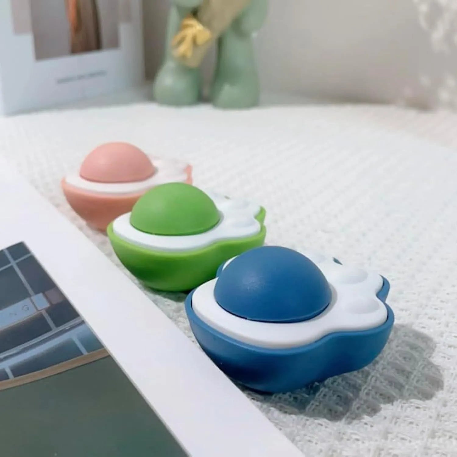 Blue plush catnip mouse toy with edible lick surface for dental health, shown next to a green and pink version.
