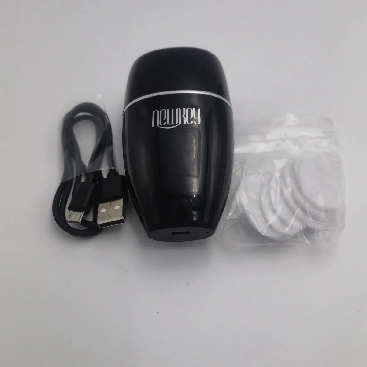 Black and white electric silicone lip plumper with USB charging cable