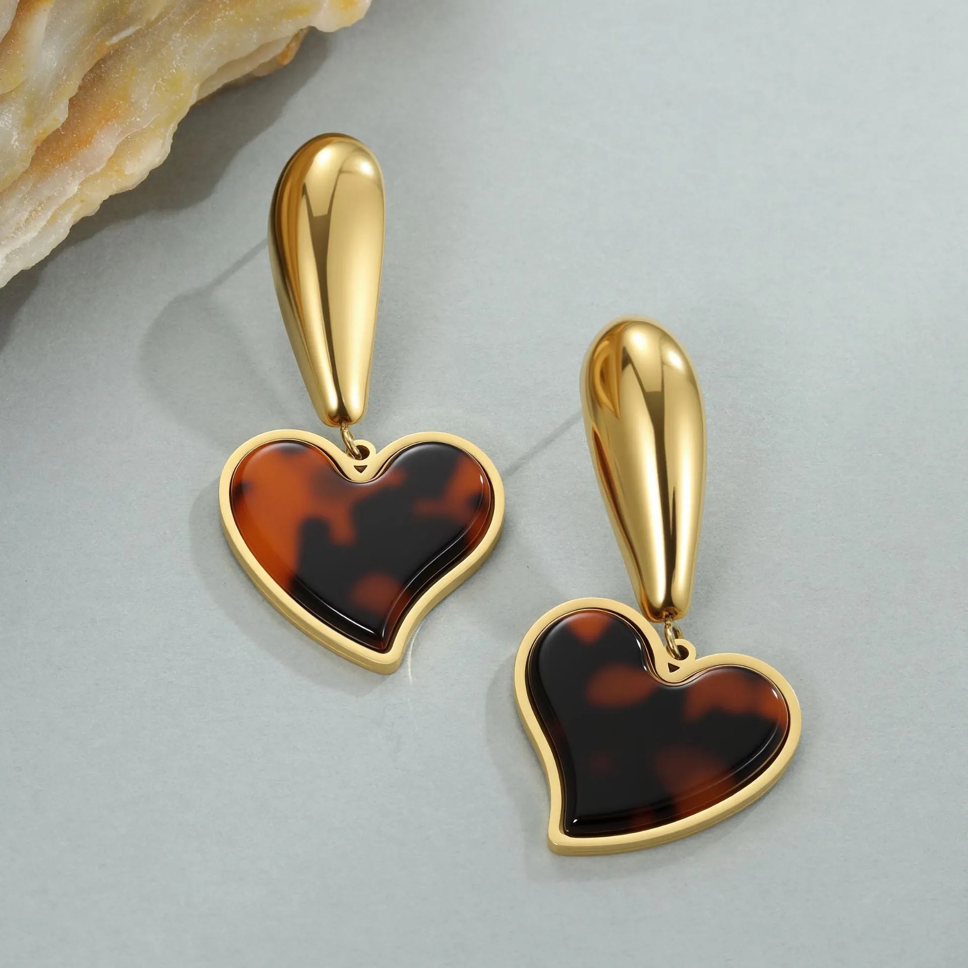 Tortoiseshell resin hawksbill colour earrings with 18K gold electroplating, showing heart-shaped and flower geometric designs