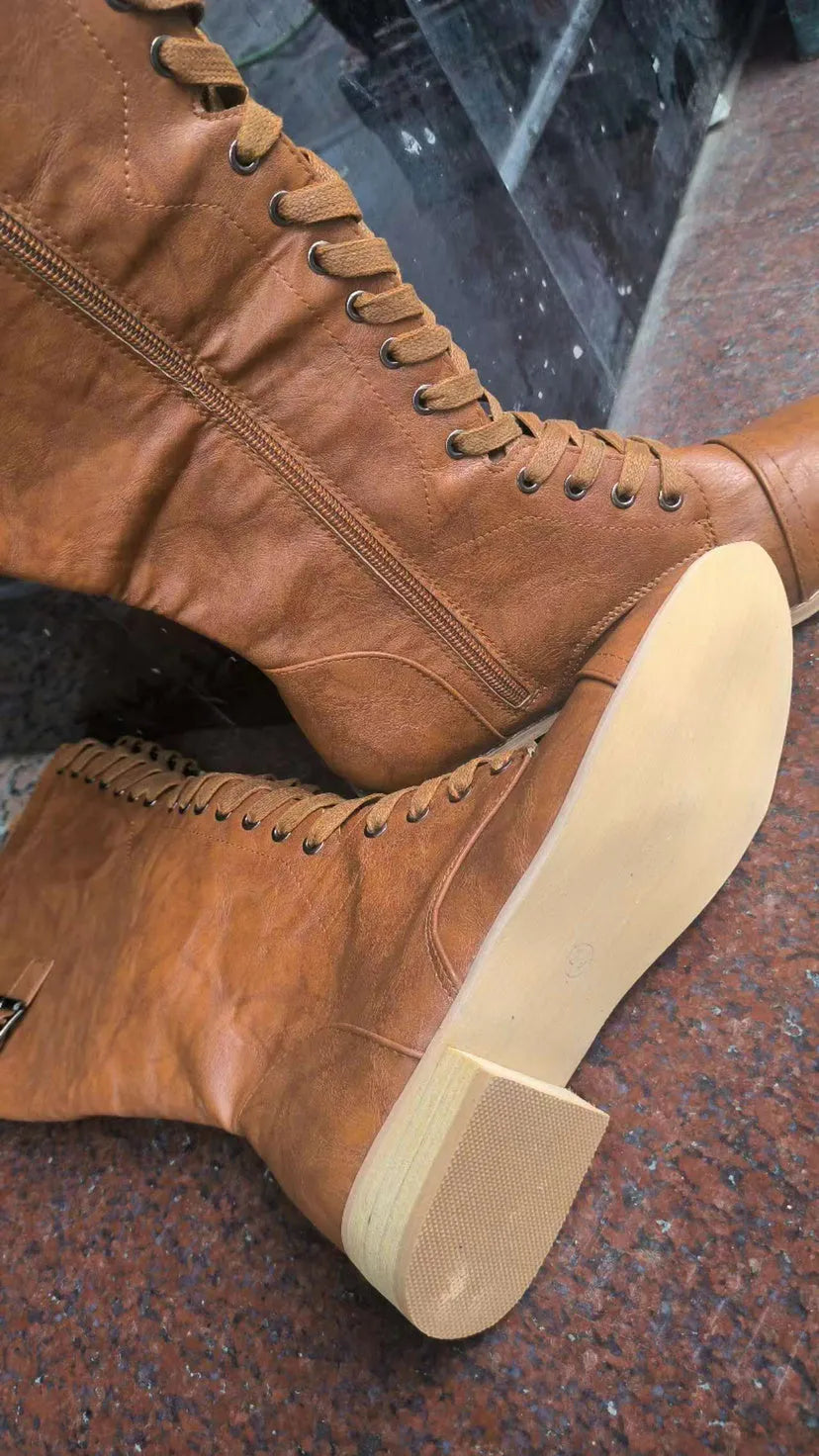 Women's black artificial PU knight boots with cross straps over the ankle.