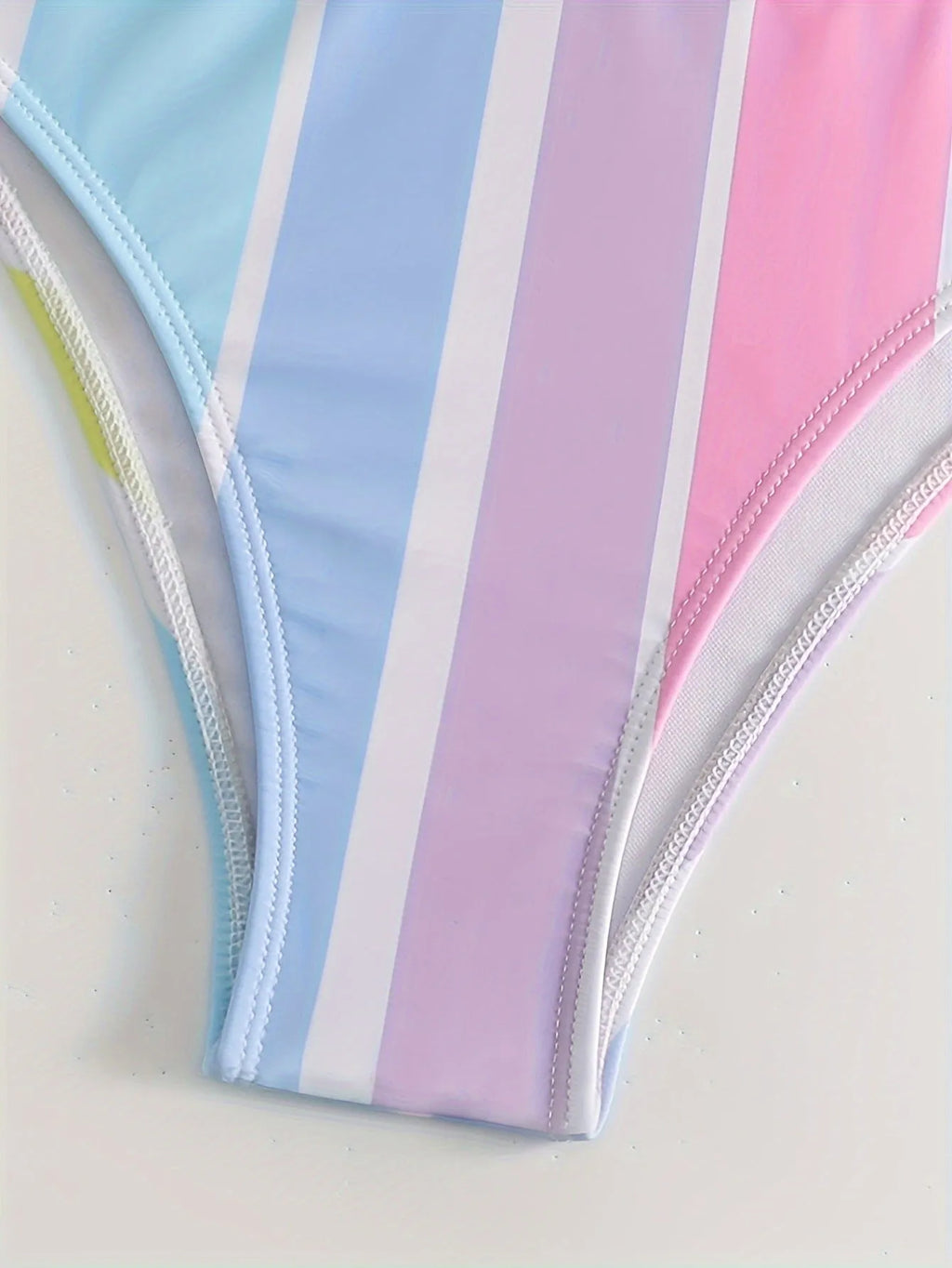 Women's striped two-piece bikini set in a sports casual design on a mannequin.