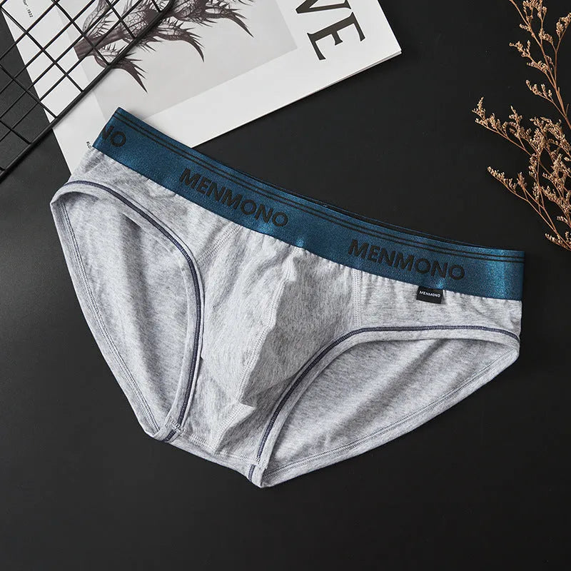 Men's low waist cotton briefs in a selection of solid colours including black and blue, white and red.