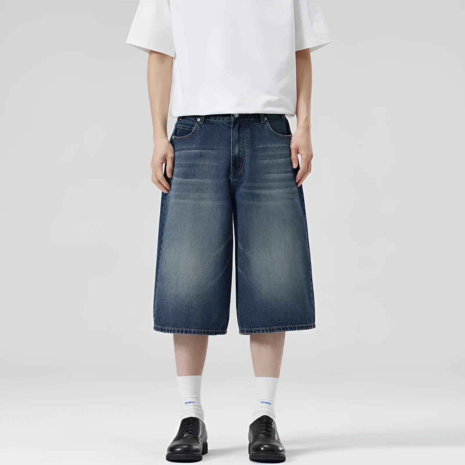 Men's light blue loose-fit cropped denim shorts with a straight leg on a neutral background.