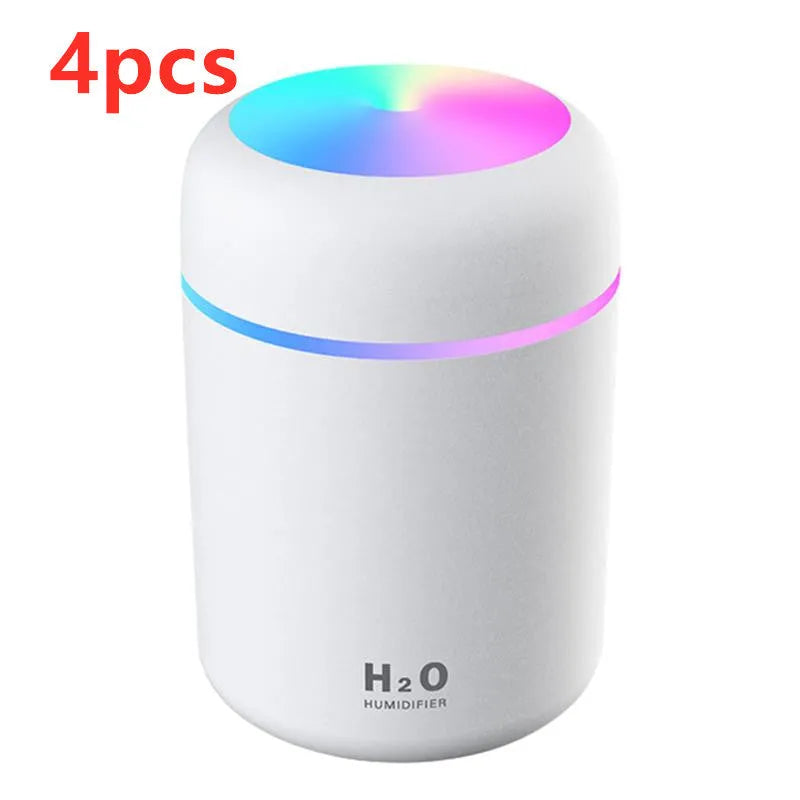 Pink USB portable humidifier with 300ml water tank on wooden desk surface