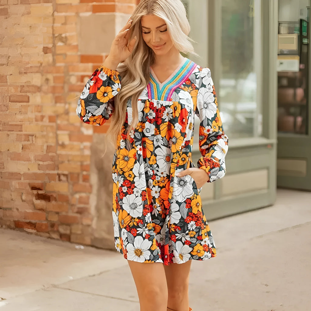 Orange floral print mini dress with lace-trimmed V-neck and long sleeves.
