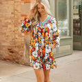 Orange floral print mini dress with lace-trimmed V-neck and long sleeves.