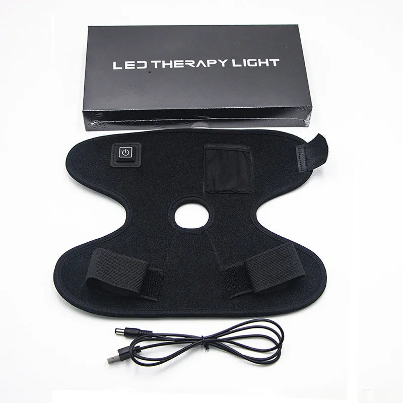 Black physical therapy ankle support with red light heat compress and USB cable