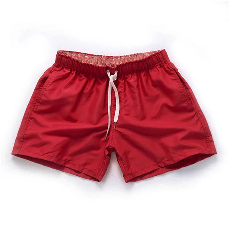 Men's straight-leg beach shorts in polyester, shown in a selection of available colours.