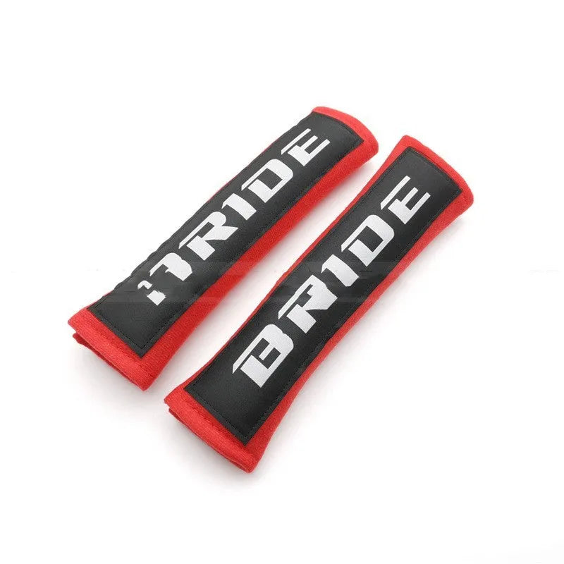 Pair of black car seat belt shoulder pads made from sponge cloth, showing embroidery detail and size.
