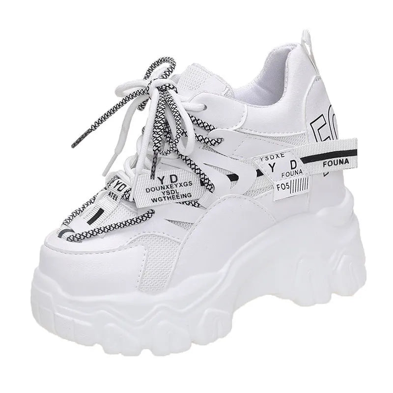 Women's white and black mesh platform sports shoes with cross-strap and rubber sole.