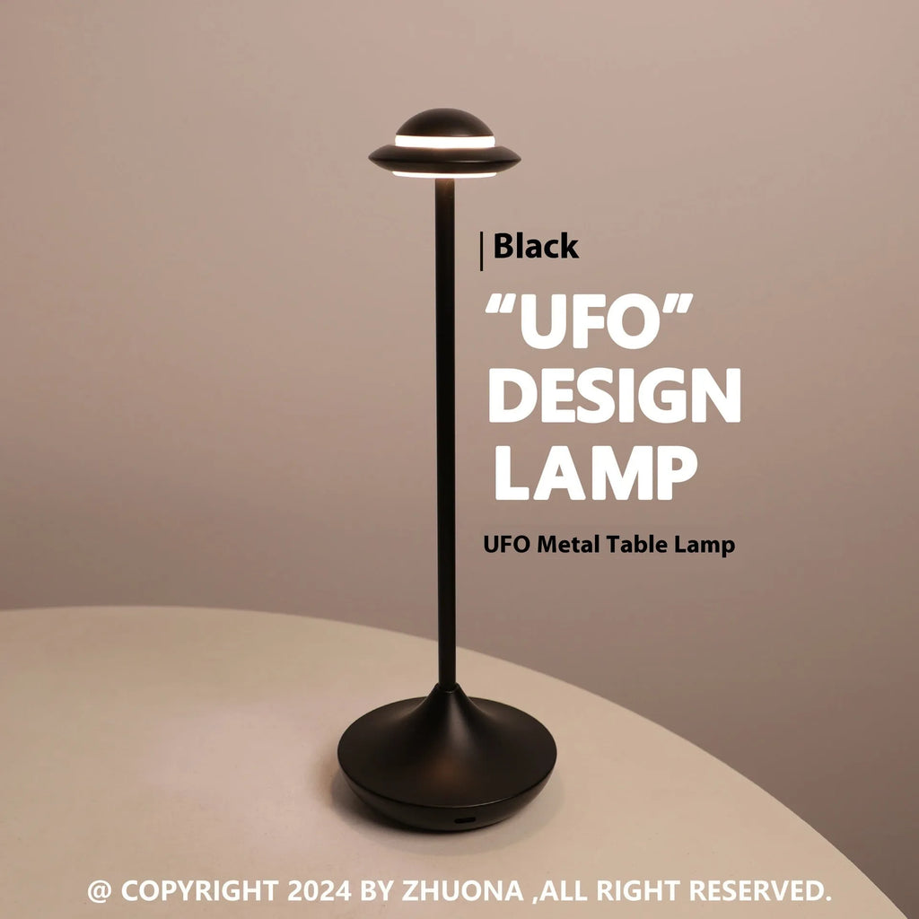 Gold UFO-shaped metal table lamp with touch dimming controls on a desk.