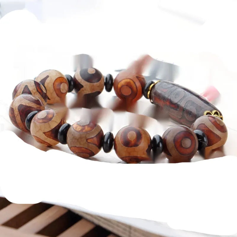 Agate Tibetan dzi bead bracelet with three-eye design and polished finish