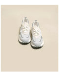 Grey and pink women's low-top retro sneakers with round toe and shallow mouth on a rubber sole.
