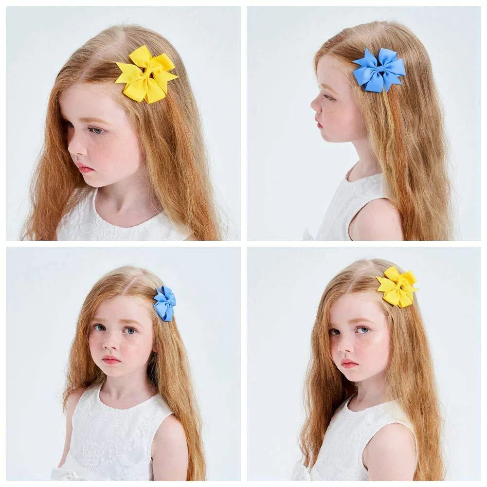 Assortment of handmade 3-inch grosgrain ribbon pinwheel hair bows with alligator clips for toddler girls in multiple colours.