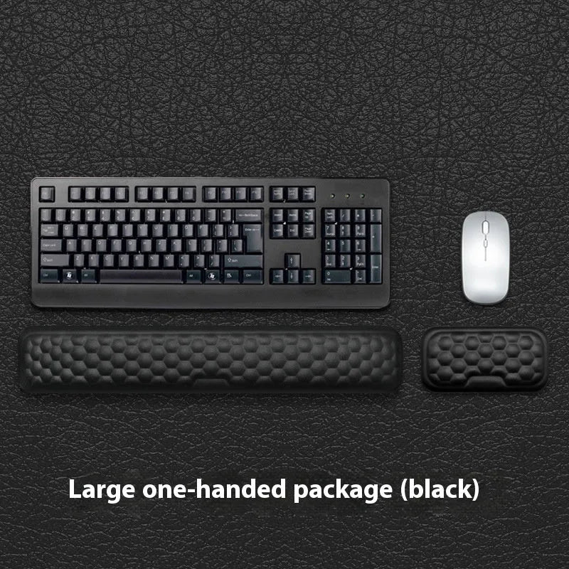 Customisable memory foam mouse wrist pad with black cloth cover on a desk.