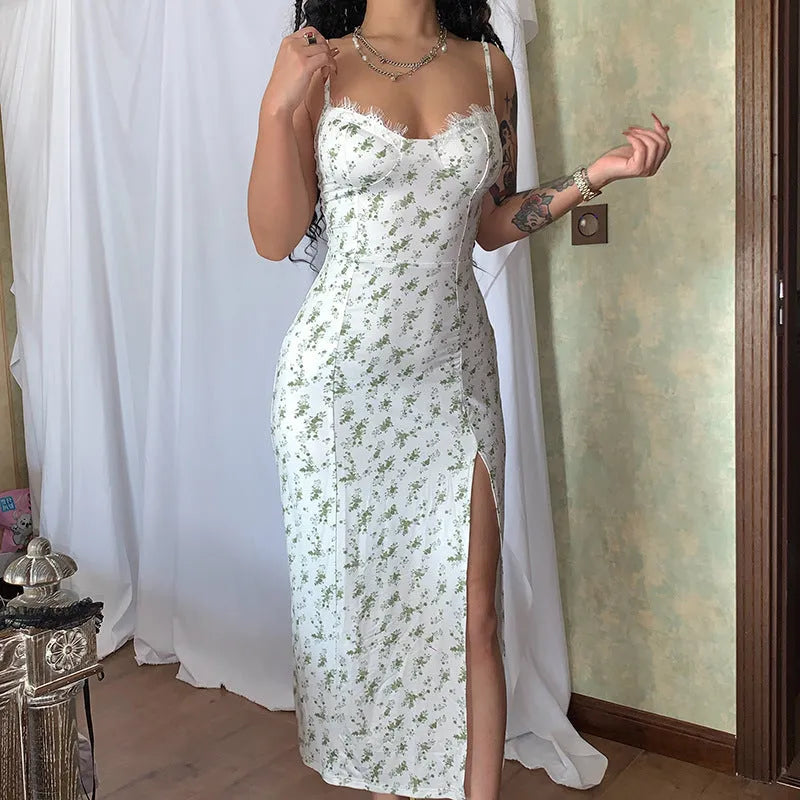 Women's long summer dress with lace flower print, suspender straps, and a high-leg slit.