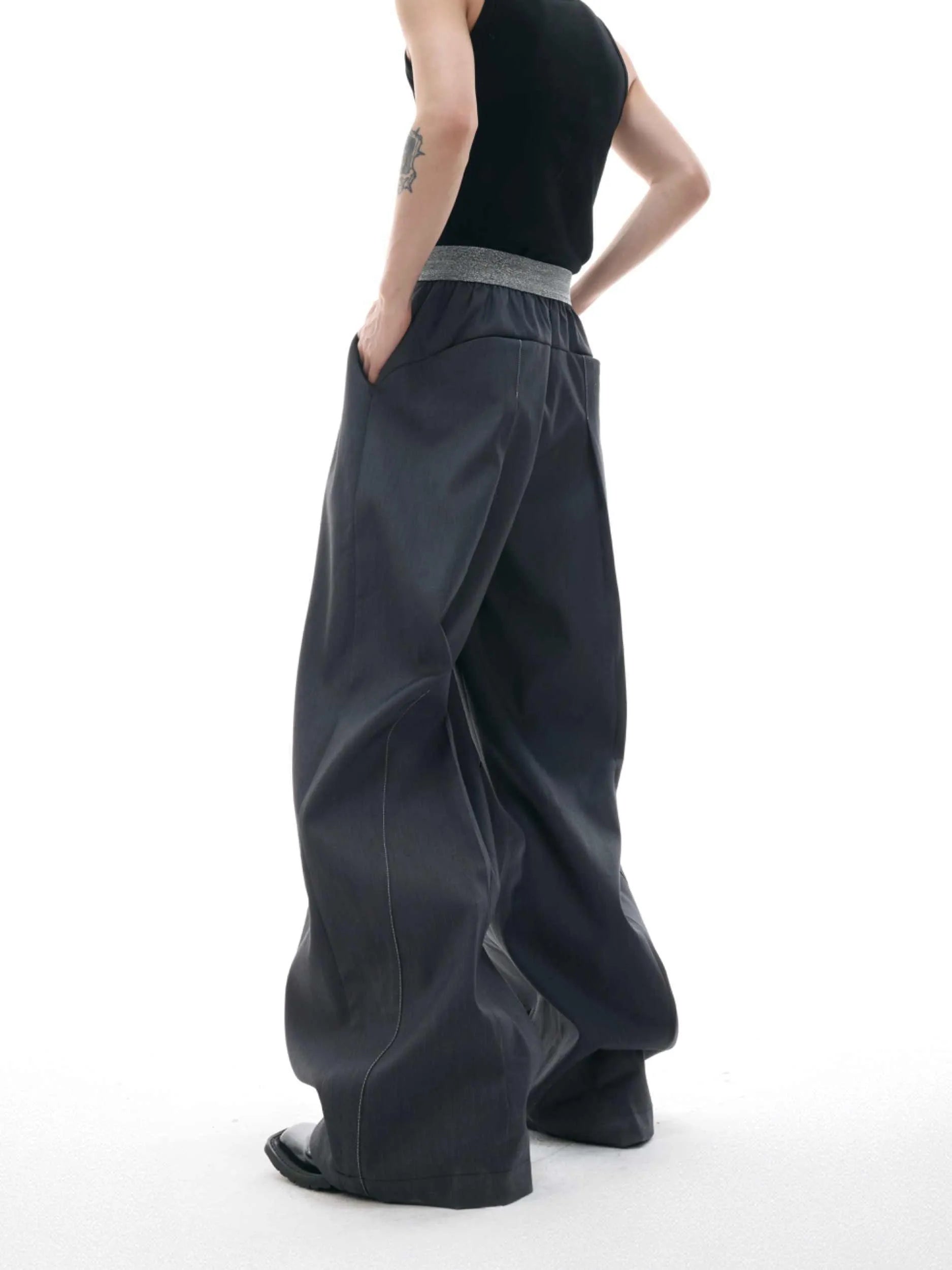 Black straight-leg high-waist trousers with button detail on smart casual model