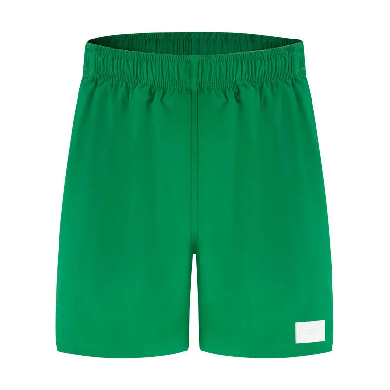 Men's solid colour quick-dry nylon sports shorts on a beach background