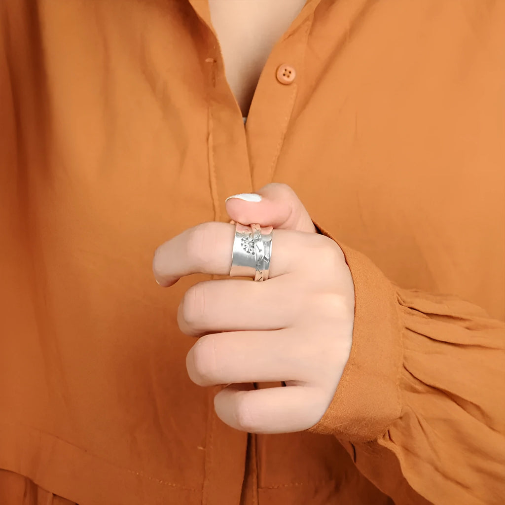 Silver rotatable flower fashion ring showing adjustable floral element and band