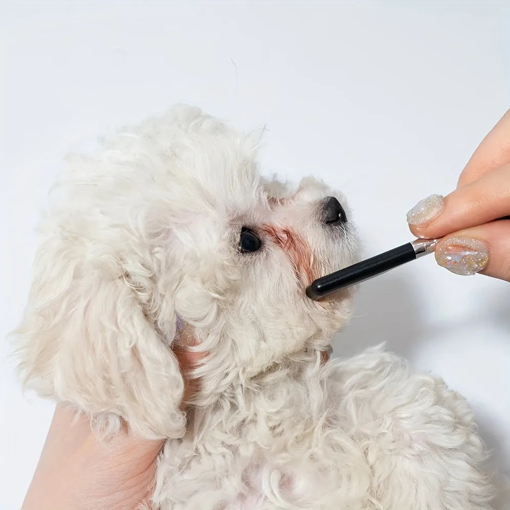 Black ambidextrous pet grooming brush with soft bristles for tear stain removal on dogs and cats