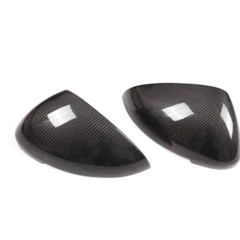 Black true carbon fibre rearview mirror cover for Porsche Macan on a white background