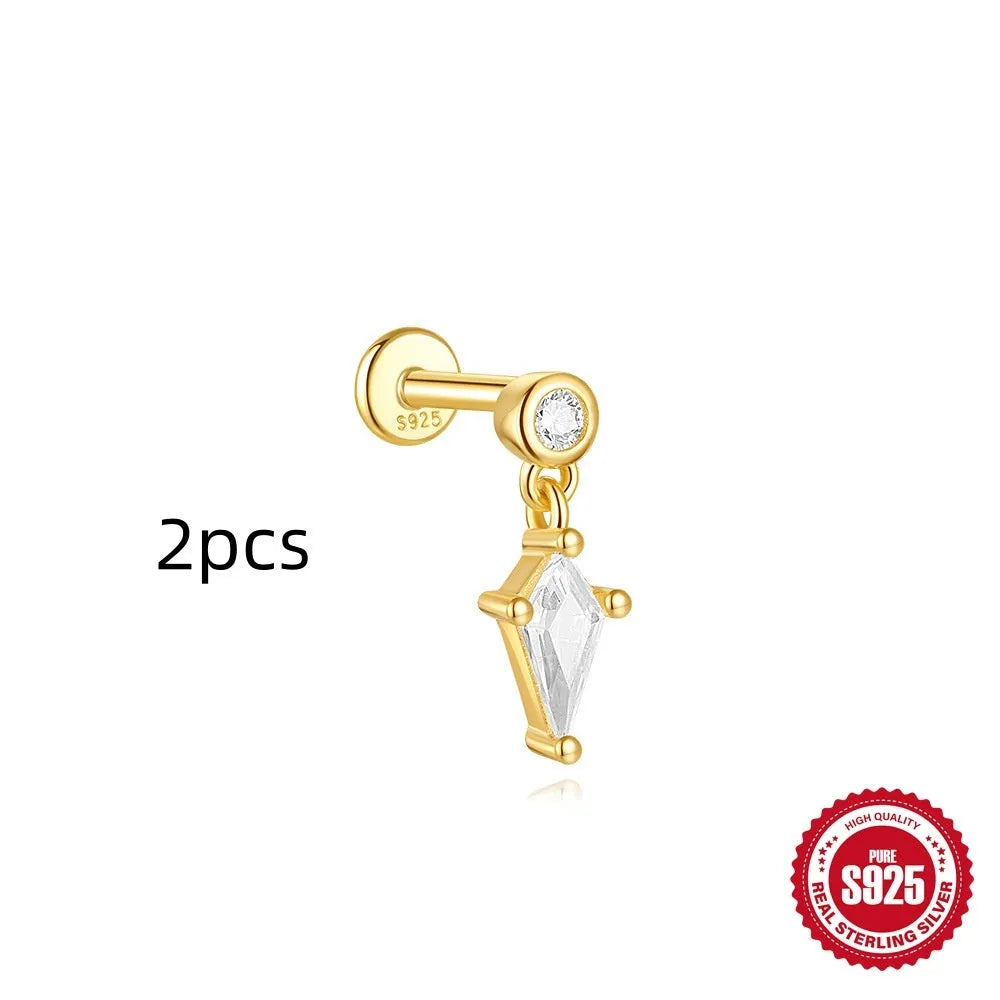 Geometric kite-shaped sterling silver earring with rhinestone head and gold chain tassel.