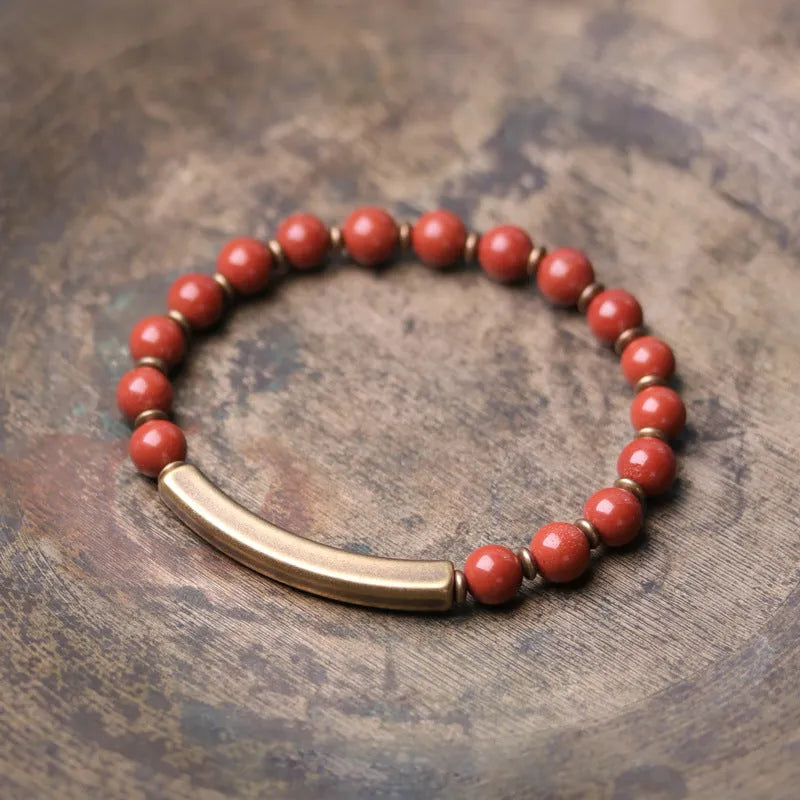 Layered ethnic bracelet with natural agate stones and brass charms on wrist