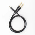 3.5mm to 6.35mm male-to-male audio cable with gold-plated connectors on a black coiled cable.