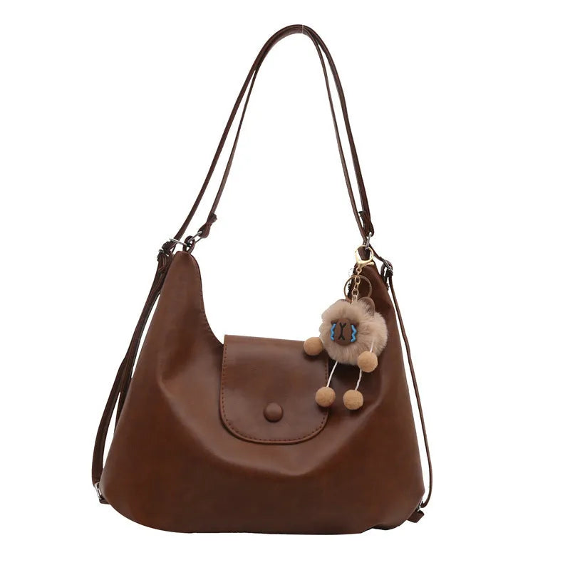 Large capacity PU leather commuter backpack with single shoulder strap in horizontal square design