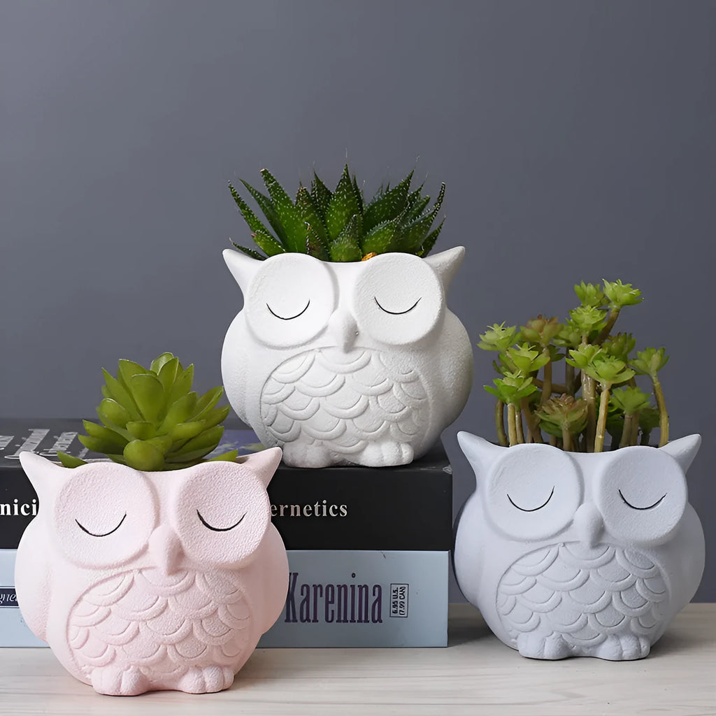 Handmade frosted ceramic flower pot with cartoon owl design, shown in light pink colour.